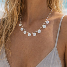 Load image into Gallery viewer, Blond beach girl wearing shiva shell necklace. 